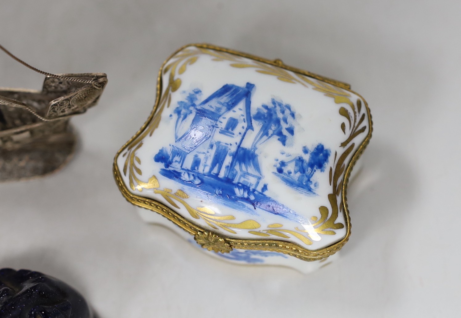 A silver mounted hinged folding wallet, 7.5 x 12cm, together with a filigree ship, a gilt and blue Limoges box and two animal figures